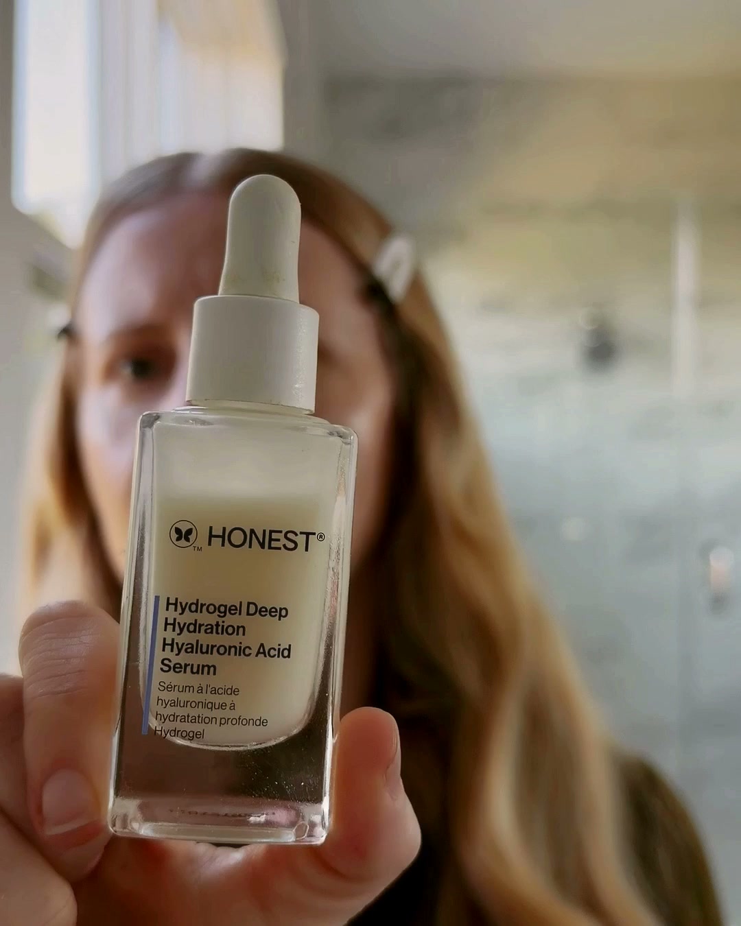 Honest Hydrogel hyaluronic acid serum held up to the camera