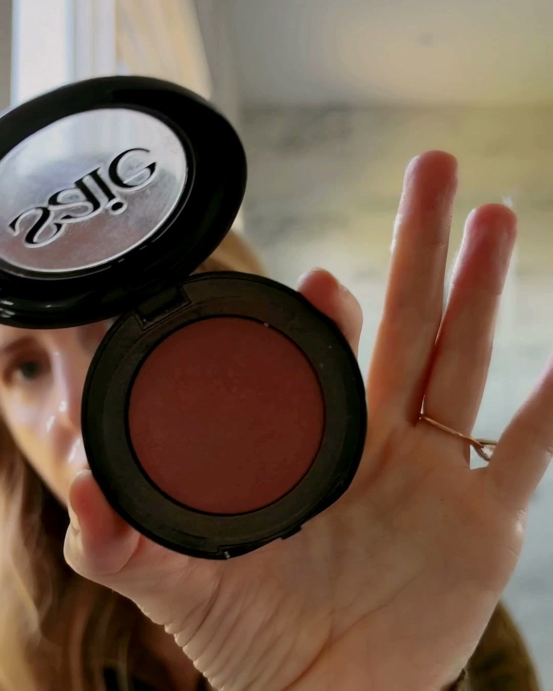 Saie blush compact held open